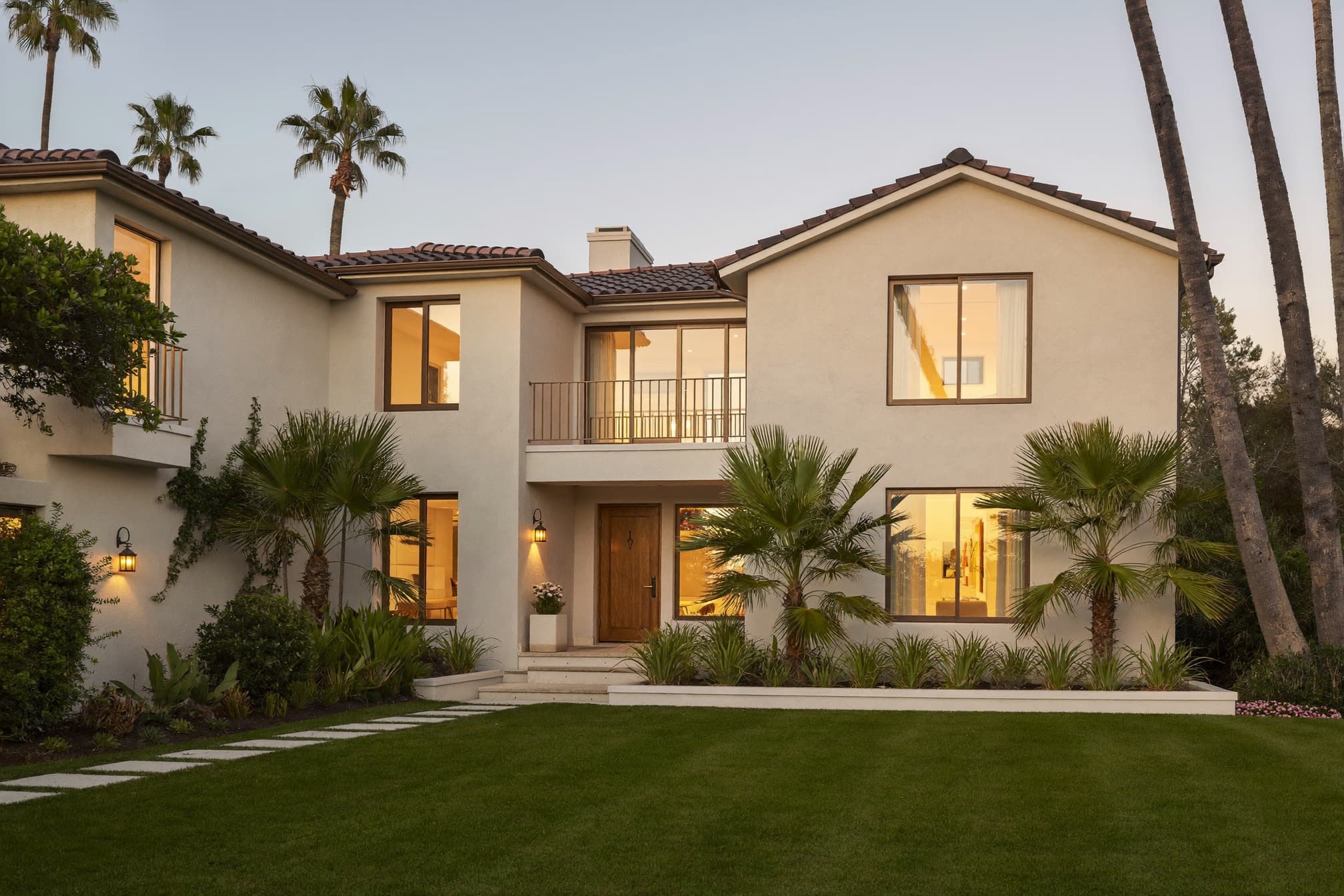 A Florida home with warm lit windows at golden hour